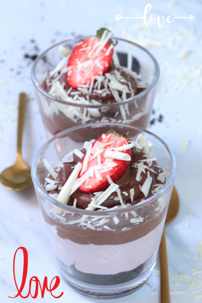 Oreo crumbs, mascarpone chocolate cream, and strawberry cream in a glass.